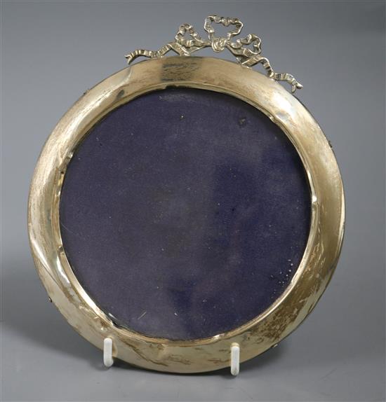 A George V circular silver mounted photograph frame, with ribbon crest, 15cm.